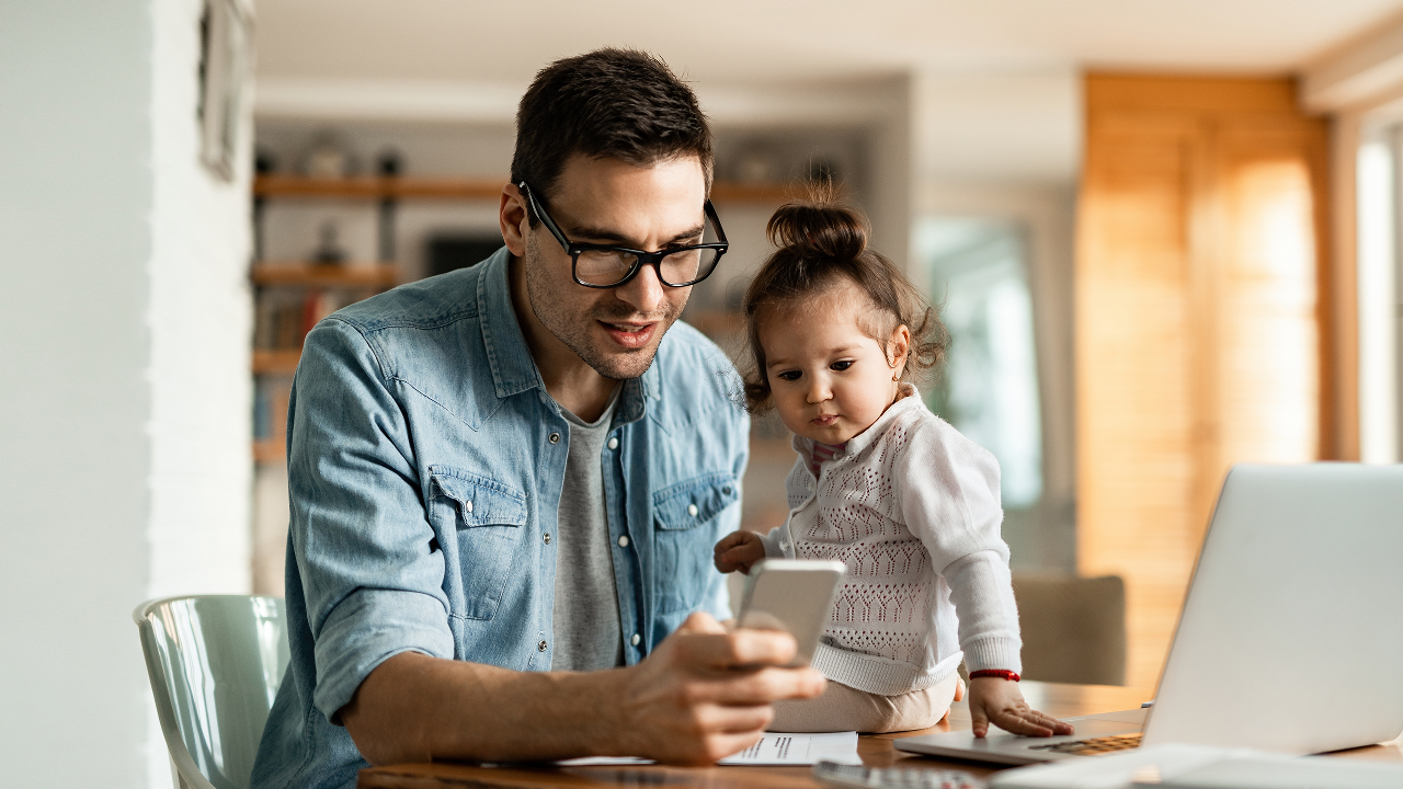 man and child on phone; image used for the HSBC Sri Lanka Banking at Home Page