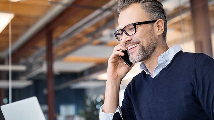 A businessman is talking over phone; image used for HSBC Sri Lanka Telephone Banking landing page.